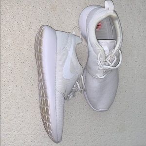 All white Nike tennis shoes